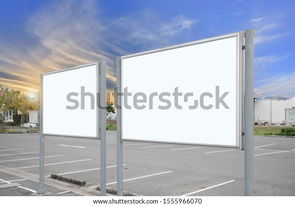 mock up of\
blank showcase billboard or advertising light box for your text\
message or media content with car in the parking lot in row,\
commercial, marketing and advertising\
concept.
