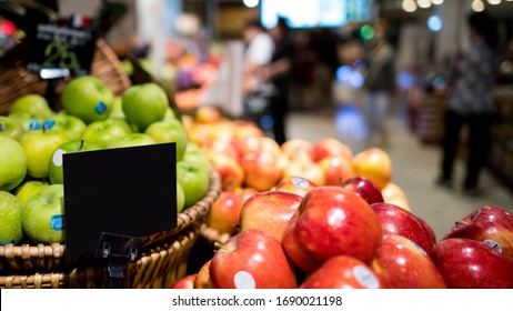 Mock Up Blank Sign Price Tag Display In Supermarket Interior, Apple Basket. Retail Fresh Supermarket For People Shopping In The Blur Background Concept. 