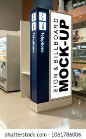 Mock Up Blank Vertical Advertising Signboard On The Wall Of Public Telephone Booth Inside Terminal With Clipping Path, Nearly Beverage Vending Coin Machine