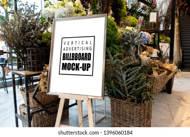 Mock Up Blank Vertical Advertising Signboard In Frame On Wooden Stand With Clipping Path In Flower Decoration Shop, Empty Space For Insert Message Or Media Advertisement Indoo