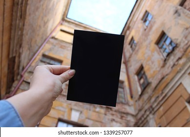 Mock Up Card, Post Card Or Advertising Leaflet Of Standard A5 Size On On The Background Of Old Houses, Old Courtyard With Yellow Dilapidated Houses