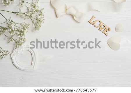 Mock up Composition of white flowers rustic style, hearts love and a gift for St. Valentine's Day with a place for your text. Flat lay, top view photo mock up.