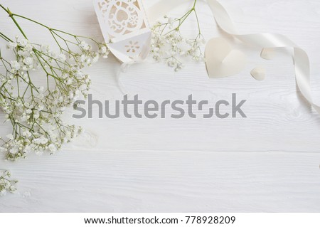 Mock up Composition of white flowers rustic style, hearts and a gift for St. Valentine's Day with a place for your text. Flat lay, top view photo mock up