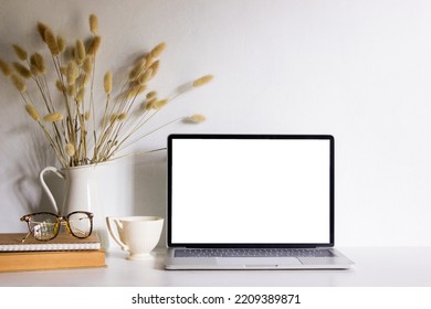 Mock Up Computer With Books, Eyeglasses, Coffee Cup And Flowers On White Table. 