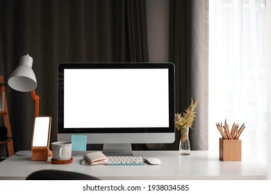 Mock Up Computer And Smart Phone With White Screen On White Table At Comfortable Home Office.