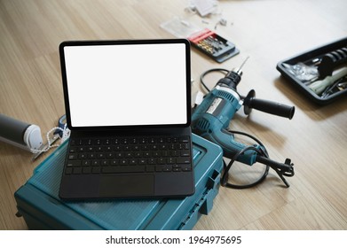 Mock up computer tablet and construction tools wooden floor.