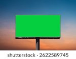 Mock up concept - green screen billboard on highway with traffic at evening time at beautiful sunset