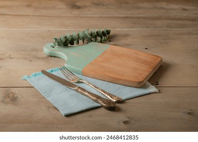 mock up decorative table setting of wooden kitchen cutting board with vintage cutlery on wooden rustic table - Powered by Shutterstock