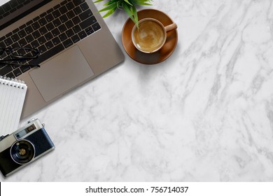 Mock Up Desk Work Vintage Camera, Laptop, Notebook And Plant On Marble Table Background. Top View And Copy Space. 