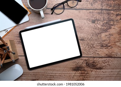Mock up digital tablet with blank screen on wooden desk. Top view. - Shutterstock ID 1981052006