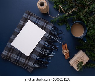 Mock up of empty paper , blue cup of coffee on the blue table next to a scarf with a postcard and Christmas tree . Flat Lay with no people . Cup of coffee and cinnamon. Christmas gift in kraft - Powered by Shutterstock