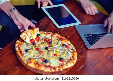 Mock up freelancer workplace. Tablet PC, cell phone and pizza. Top view image. Fast pizza delivery