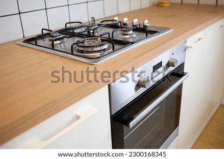 mock up gas stove in the minimal style kitchen with white and brown color