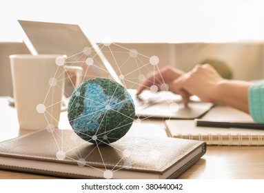 mock up the globe with digital social media network on notebook at office background.