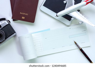 Mock up image of blank cashing check , pen, two passports,digital tablet, plane model and camera on white background. trip and travel, Promotion and paycheck concept. - Shutterstock ID 1240494685