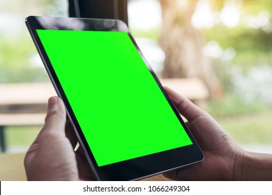 Mock Up Image Of Hands Holding Black Tablet Pc With White Blank Screen And 