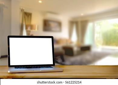 Mock Up Laptop Blank Screen On Wooden Table In Living Room.