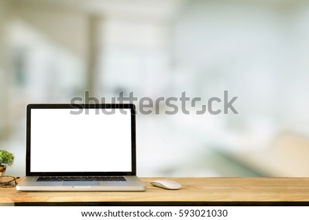 Mock up Laptop Blank Screen on work table in office.