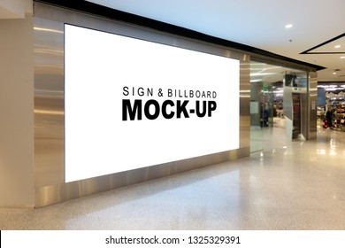 Mock up large billboard with clipping path at corridor, perspective white screen empty space for advertisement on the wall near walkway in the shopping mall