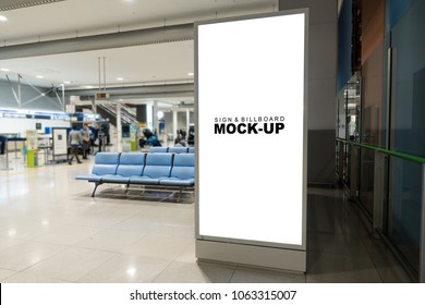 Mock Up Large Blank Vertical Advertising Billboard On The Panel Inside Airport Terminal With Clipping Path, Nearly Empty Seat And Blurry Background