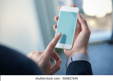 Mock up of a man holding device and touching screen.