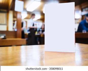 Mock Up Menu Frame On Table In Bar Restaurant Cafe Background With People