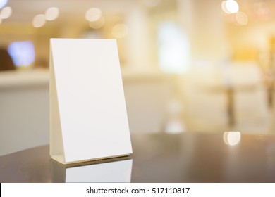 Mock Up Menu Frame On Table In Bar Restaurant ,Stand For Booklets With White Sheets Of Paper Acrylic Tent Card On Cafeteria Blurred Background