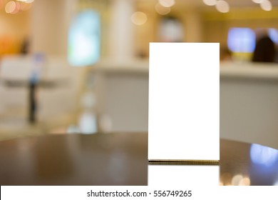 Mock Up Menu Frame On Table In Bar Restaurant ,Stand For Booklets With White Sheets Of Paper Acrylic Tent Card On Cafeteria Blurred Background