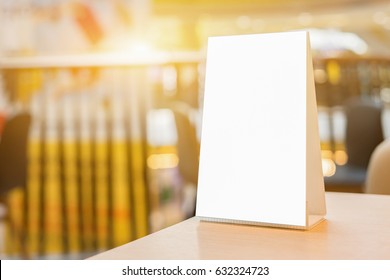 Mock Up Menu Frame On Table In Bar Restaurant ,Stand For Booklets With White Sheets Of Paper Acrylic Tent Card On Cafeteria Blurred Background