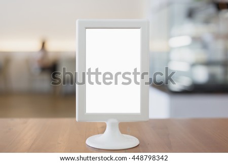 Mock up menu frame on table in coffee shop.