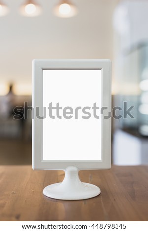 Mock up menu frame on table in coffee shop.