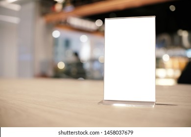 Mock up Menu frame standing on wood table in Bar restaurant cafe. space for text. - Shutterstock ID 1458037679