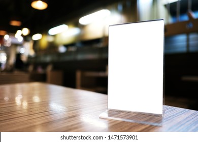 Mock Up Menu Frame Standing On Wood Table In Bar Restaurant Cafe. Space For Text.