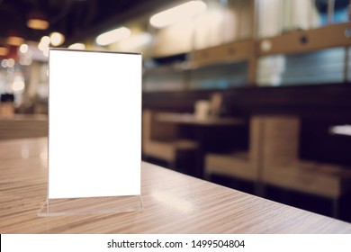 Mock up Menu frame standing on wood table in Bar restaurant cafe. space for text. - Shutterstock ID 1499504804