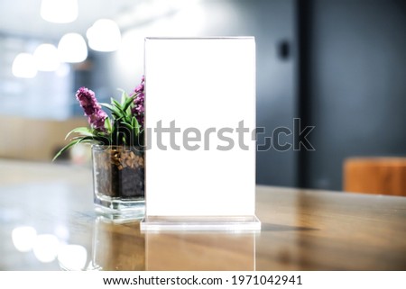 Mock up Menu frame. standing on wood table in Bar restaurant cafe. space for text. Menu mack up blank for text marketing promotion.