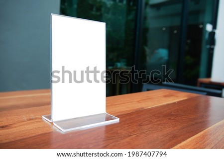 Mock up Menu frame. standing on wood table in Bar restaurant cafe. space for text. Menu mack up blank for text marketing promotion.