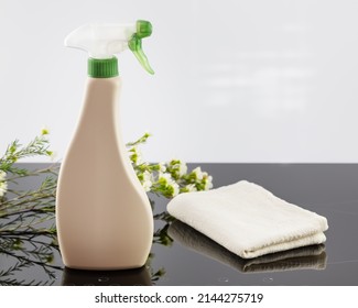 Mock up of organic cleaning products for house cleaning on a cooking panel with spring flowers. Eco friendly spring cleaning. Soft image and soft focus style. Mock up of natural stove cleaner