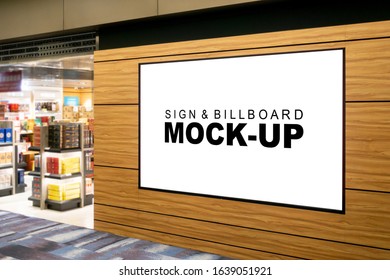 Mock Up Perspective Large Blanking Billboard Advertising With Clipping Path Near Entrance Of Souvenir Duty Free Showroom At Airport Terminal, Empty Space For Insert Advertisement Or Information