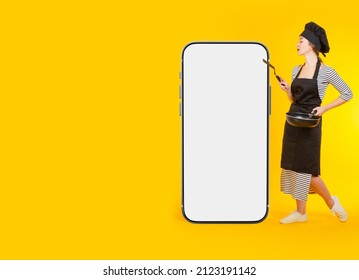 Mock Up Of Phone And Female Chef. Girl Cook Near Giant Phone. Recipe Book Advertising Concept App. Smartphone With Blank Screen For Culinary Ads. App Recommendation From Chef. Copy-space On Yellow