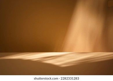 Mock up for presentation, branding products, cosmetics, food or jewellery. Empty table on bright brown wall background. Composition with window shadow on the wall and wooden table.  - Shutterstock ID 2282331283