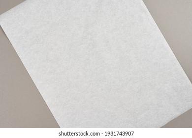 Mock up sample. White blank sheet of baking paper on a gray background.