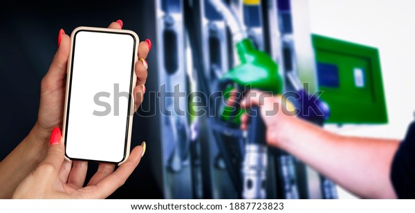 Mock up smartphone in hand\
closeup on the background of a gas station. Payment refueling\
online