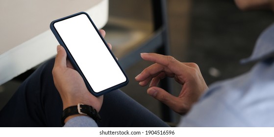 Mock Up Smartphone Of Hand Holding Black Mobile Phone With Blank White Screen.	