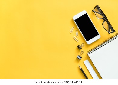 Mock up smartphone and office accessories on colorful background with copy space.view from above - Powered by Shutterstock