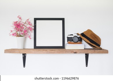 Mock Up Square Frame Photo On Wooden Shelf. Lifestyle Traveler Home Decor Concept