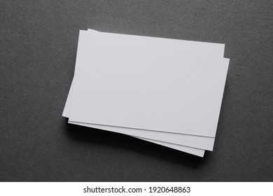 Mock up a stack of blank white cards, a grey table, space for text or a template