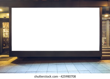 Mock up of store blank street showcase window in a city at night. Front view