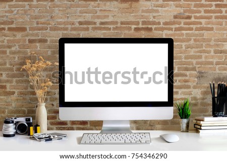 Mock up : Stylish workspace with desktop computer, creative supplies, houseplant and books at home or studio. Blank screen for graphics display montage.