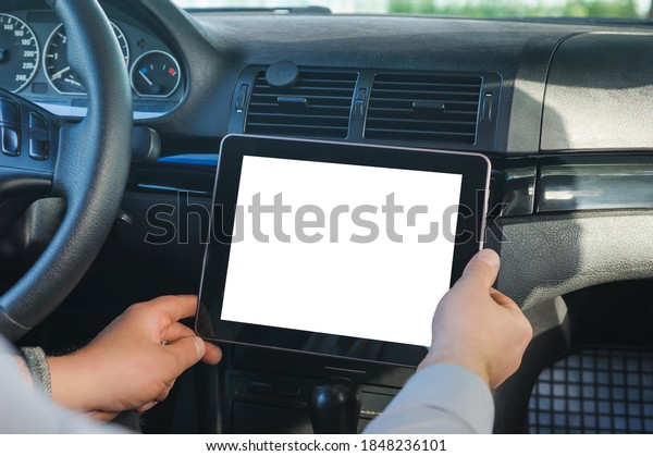 Mock up tablet in car salon. against the\
background of the\
dashboard
