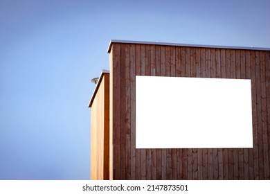 Mock Up Template. Big Horizontal White Blank Signboard, Advertising Billboard, Information Board On Modern Wooden Building Wall Outdoors